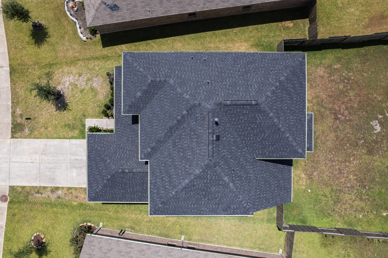 top-down view of a house with a dark grey shingled roof